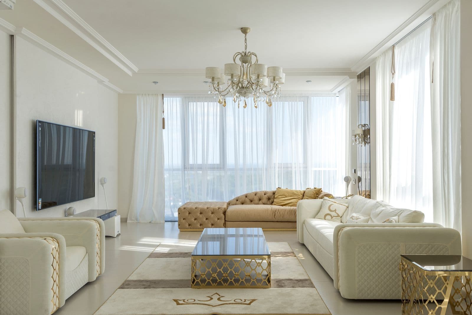 Photograph of a furnished living room with large windows